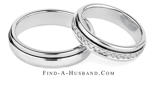 A pair of wedding rings with the website find-a-husband.com below them