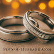 A pair of wedding rings with the website find-a-husband.com below them