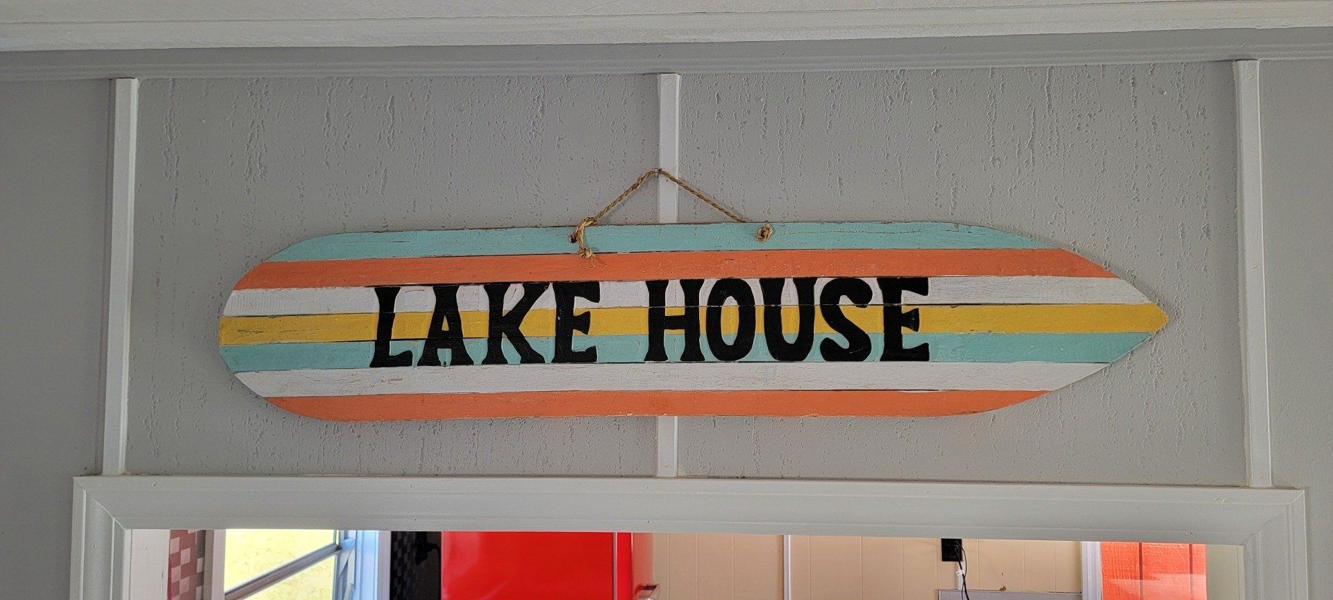 Lake House sign on striped painted surf board