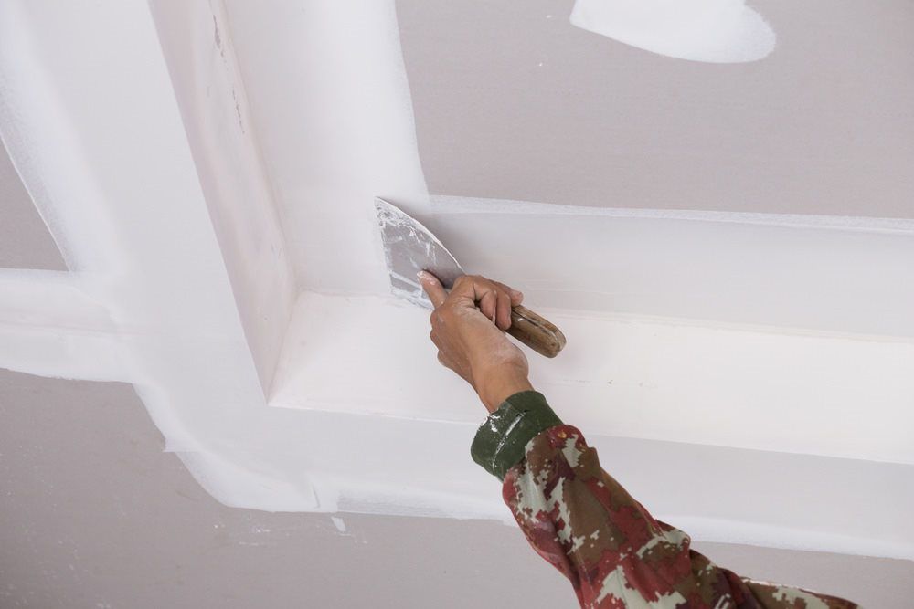 Man Plastering A Ceiling— HJK Plastering in Casino, NSW