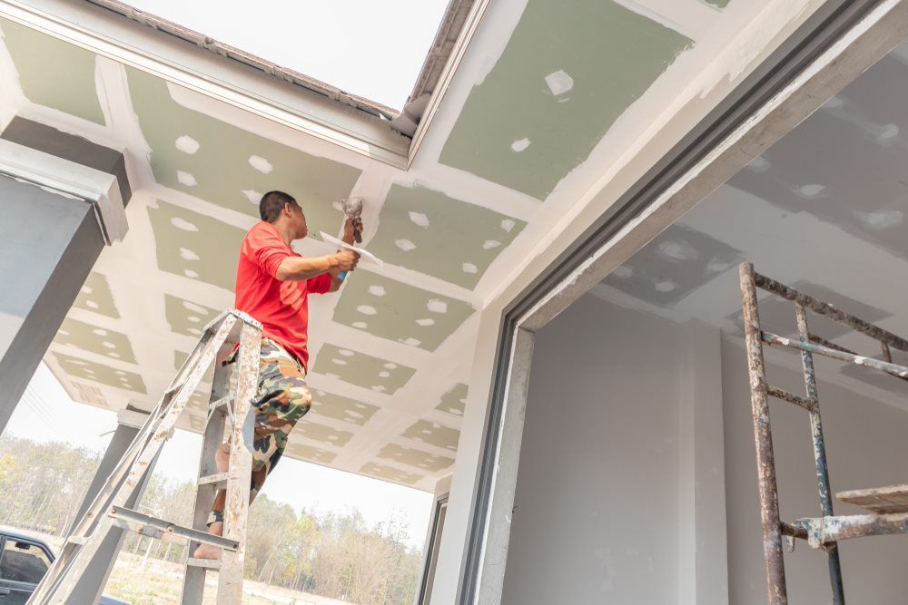 Man Plastering Wide Ceiling — HJK Plastering in South Lismore, NSW