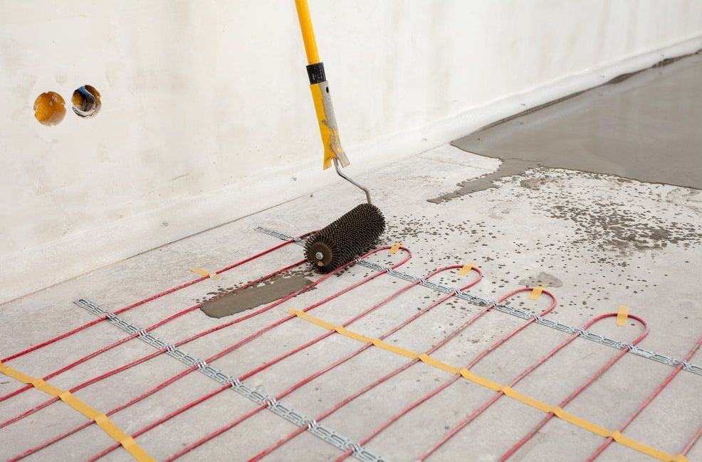 A Person is Painting a Floor With a Roller — HJK Plastering In Kyogle, NSW