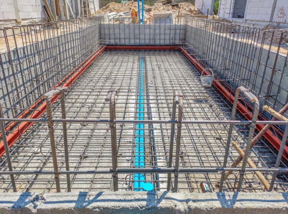 A Swimming Pool is Being Built in a Construction Site — HJK Plastering In Northern Rivers, NSW