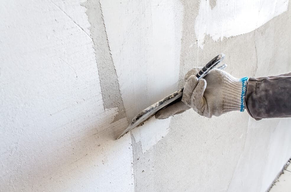 A Person is Plastering a Wall With a Trowel — HJK Plastering in Casino, NSW