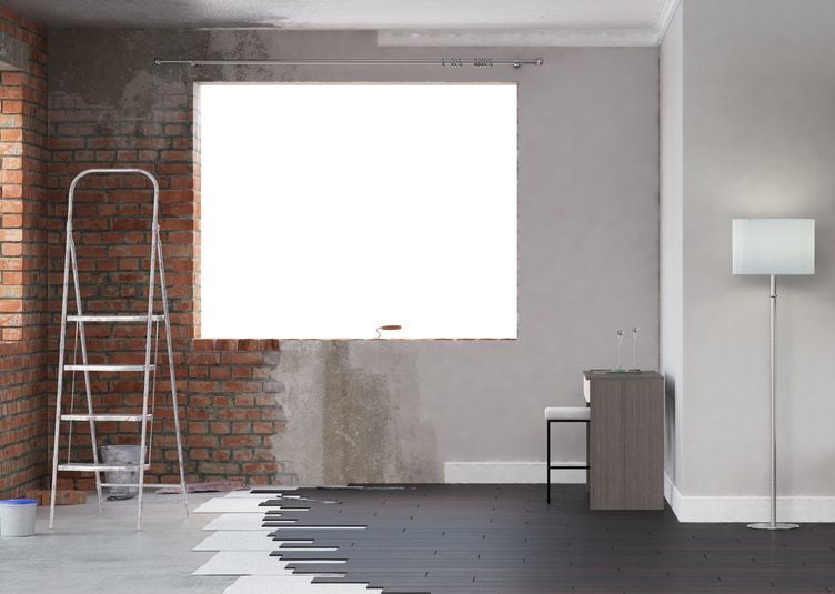 A Room is Being Remodelled With a Ladder and a Lamp — HJK Plastering In Byron Bay, NSW