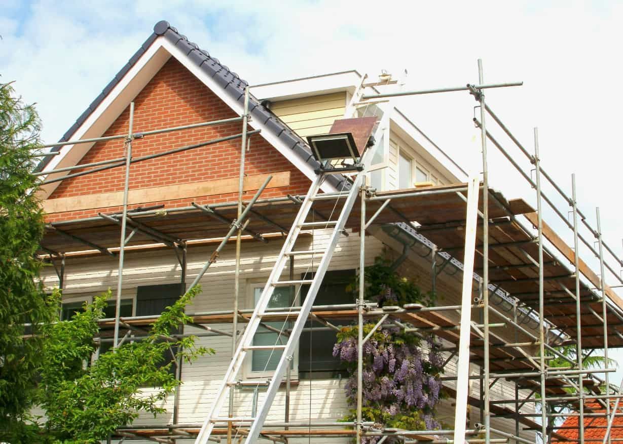 A House is Being Remodelled With Scaffolding Around It — HJK Plastering In Lennox Head, NSW