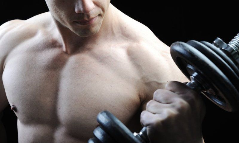 Man curling dumbbell