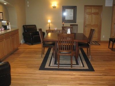 A dining room with a table and chairs and a rug