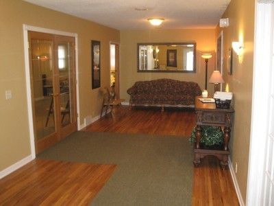 A living room with hardwood floors and a couch