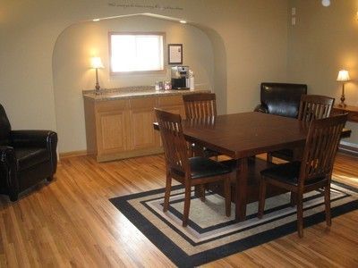 A dining room with a table and chairs and a rug