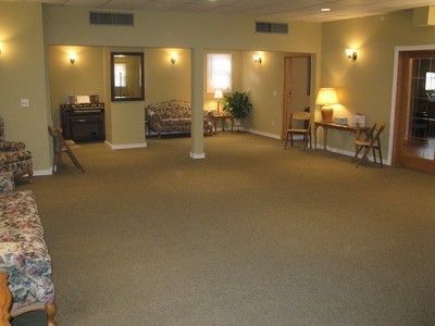 A large room with a couch and chairs in it