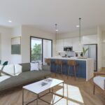 A modern living room with a green sofa and a kitchen featuring white cabinets, a blue island, and three stools.