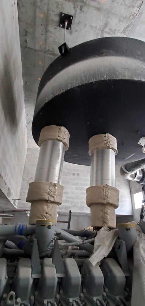 Industrial machinery with two vertical cylinders, possibly a component of a power generator or similar system.