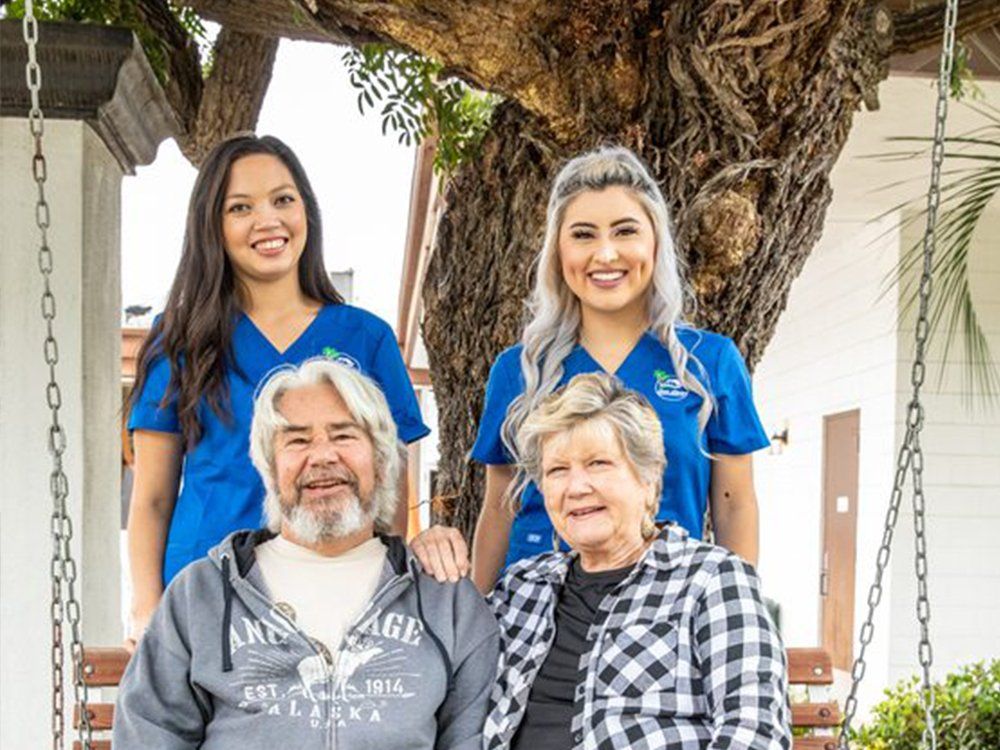 Photos of Caregiver and Senior Couple — Caregiver Pushing Senior Woman in Wheelchair  in San Marcos, CA
