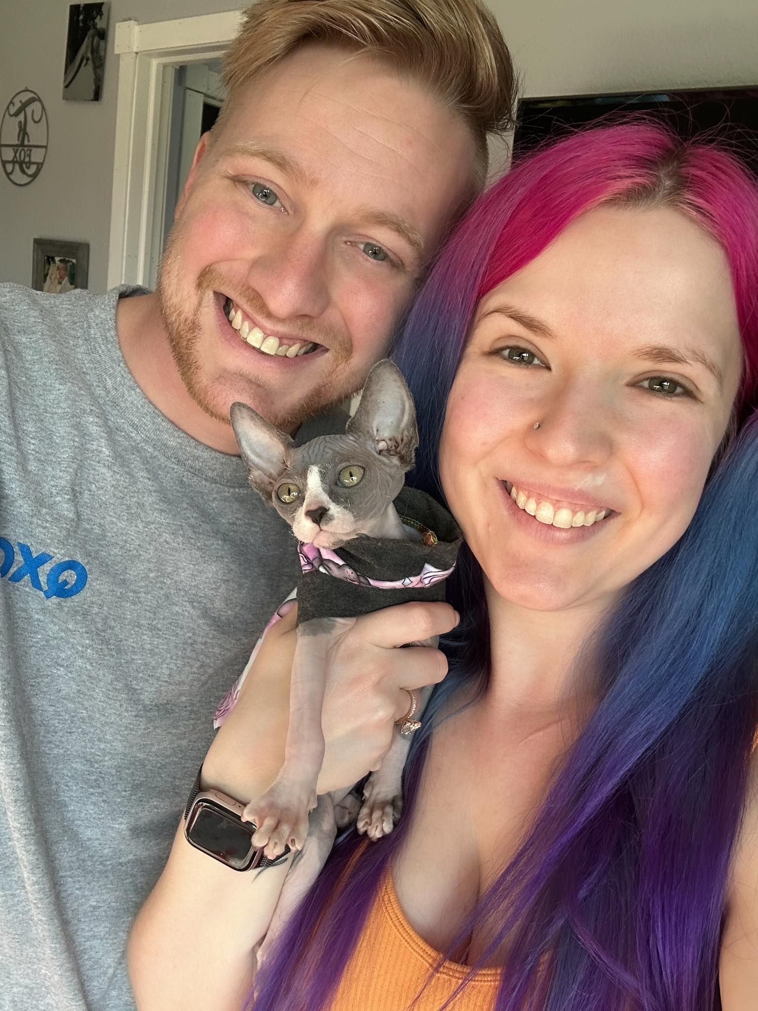 Kitten with man and women smiling