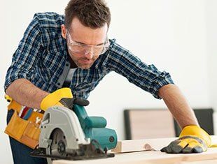 Focus Carpenter Sawing Wood Board — Contractors Tools & Fasteners in Fresno, CA