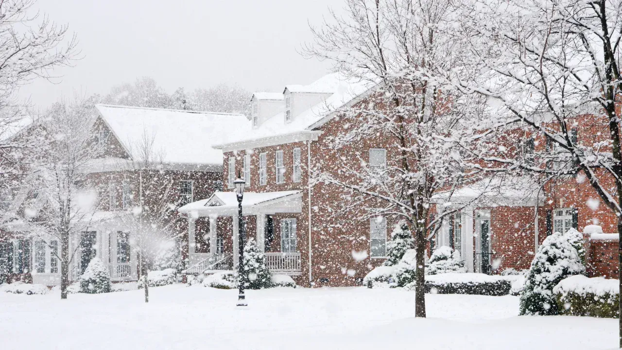 A snowstorm with large brick houses