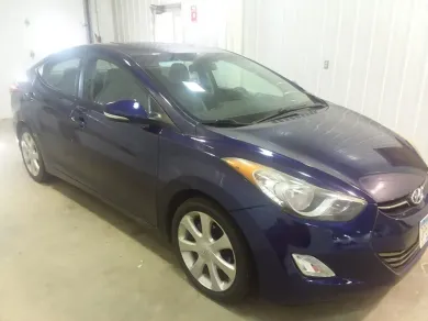 Blue Hyundai Elantra sedan parked inside a garage. | Jacobson Body Shop