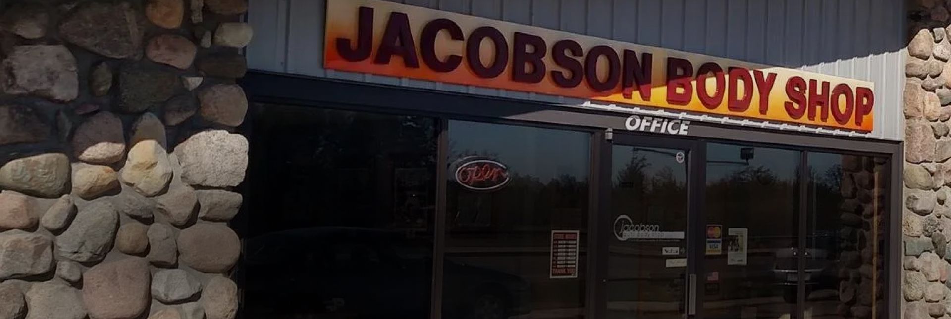 Jacobson Body Shop storefront with stone exterior and signage. | Jacobson Body Shop