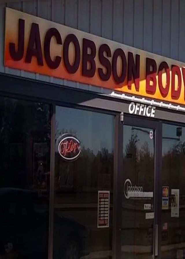 Jacobson Body Shop sign above a glass door labeled 