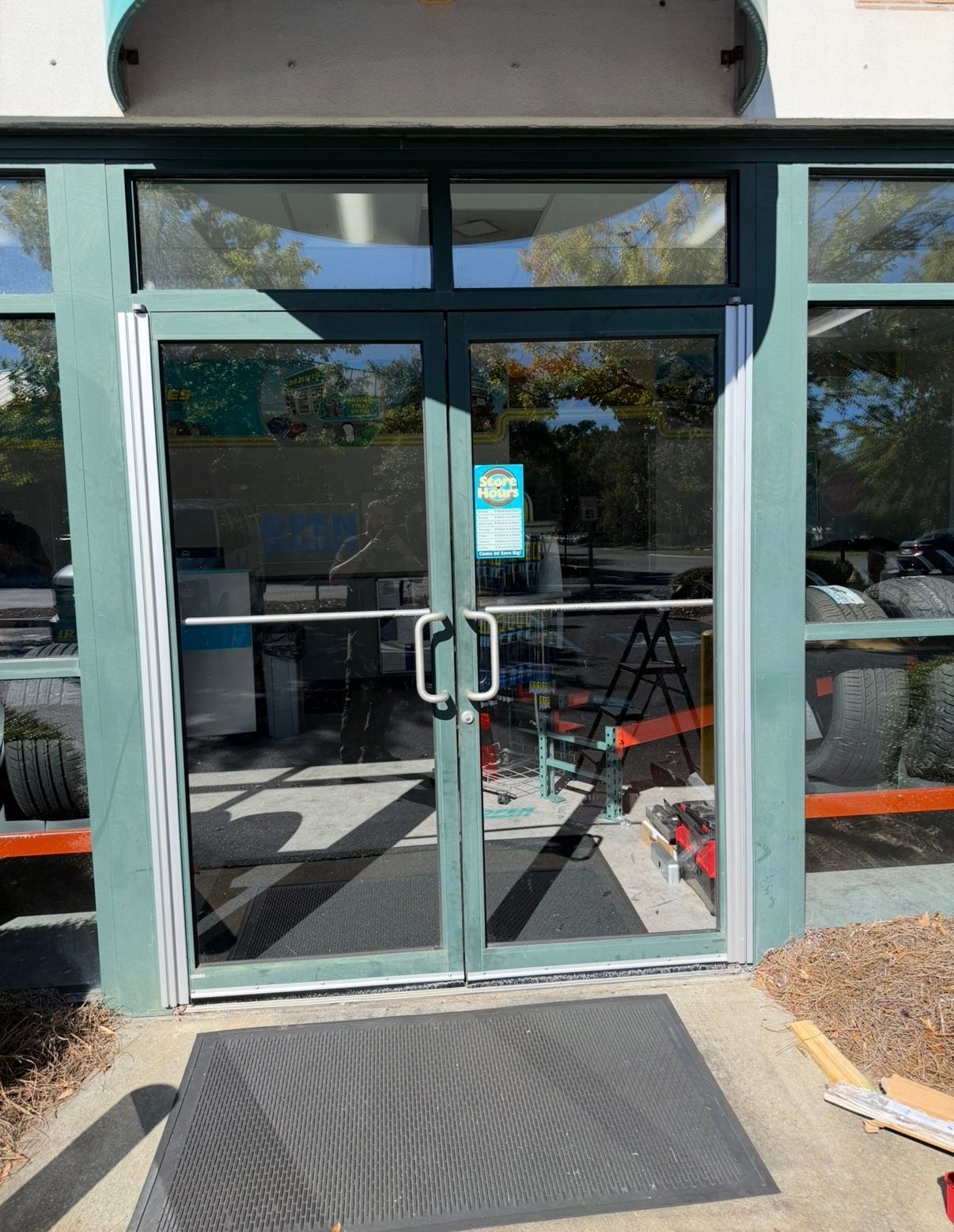 A person is fixing a door lock with a screwdriver.