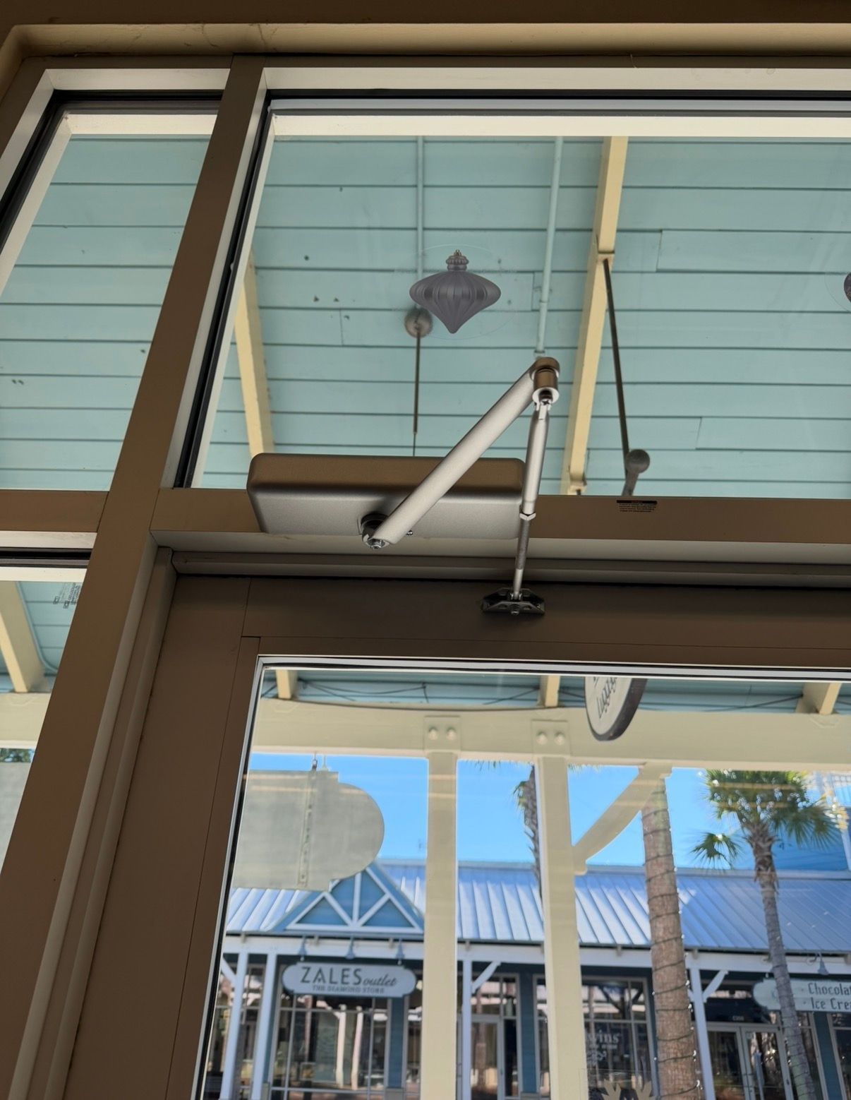 A person is fixing a door lock with a screwdriver.