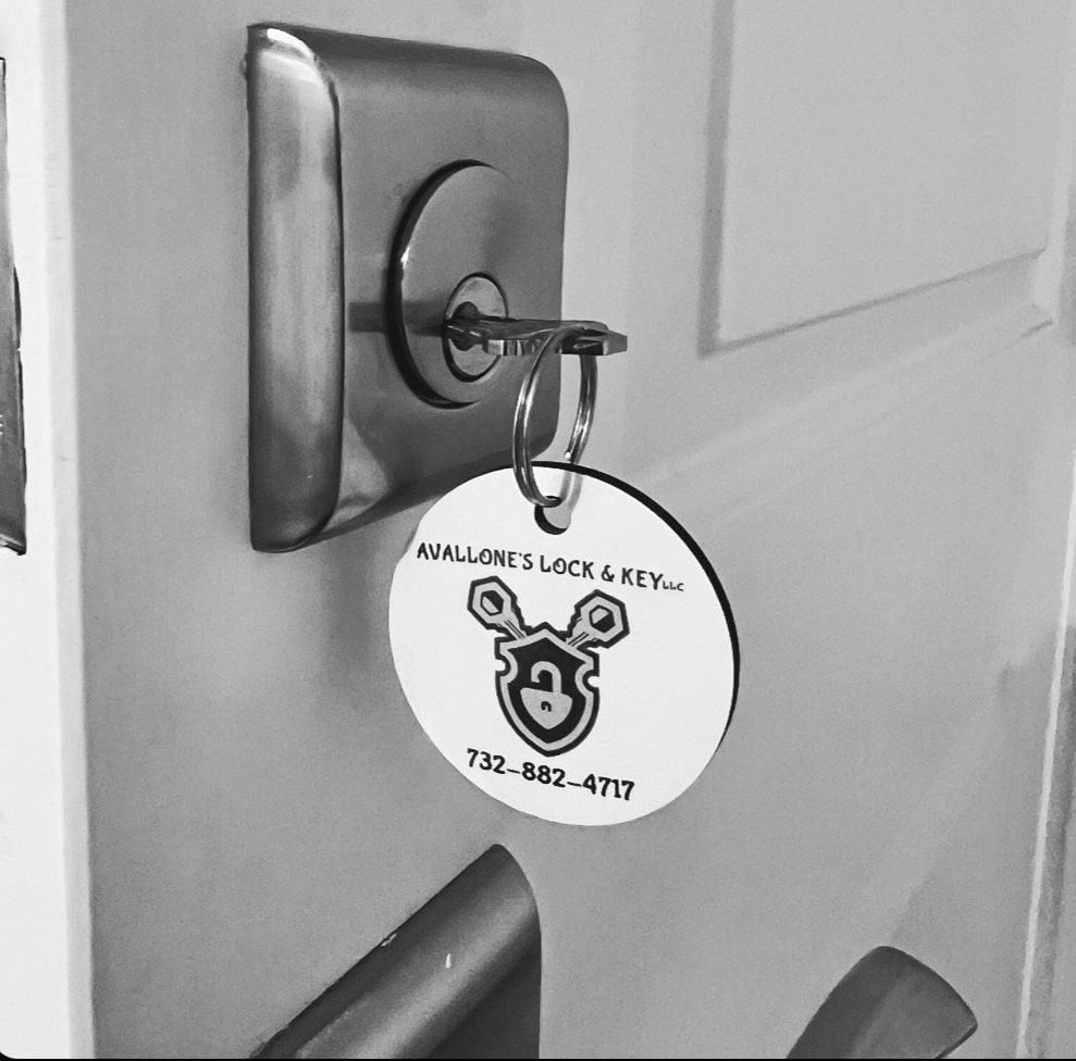 A black and white photo of a key on a door