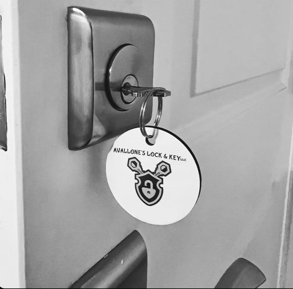 A black and white photo of a key on a door