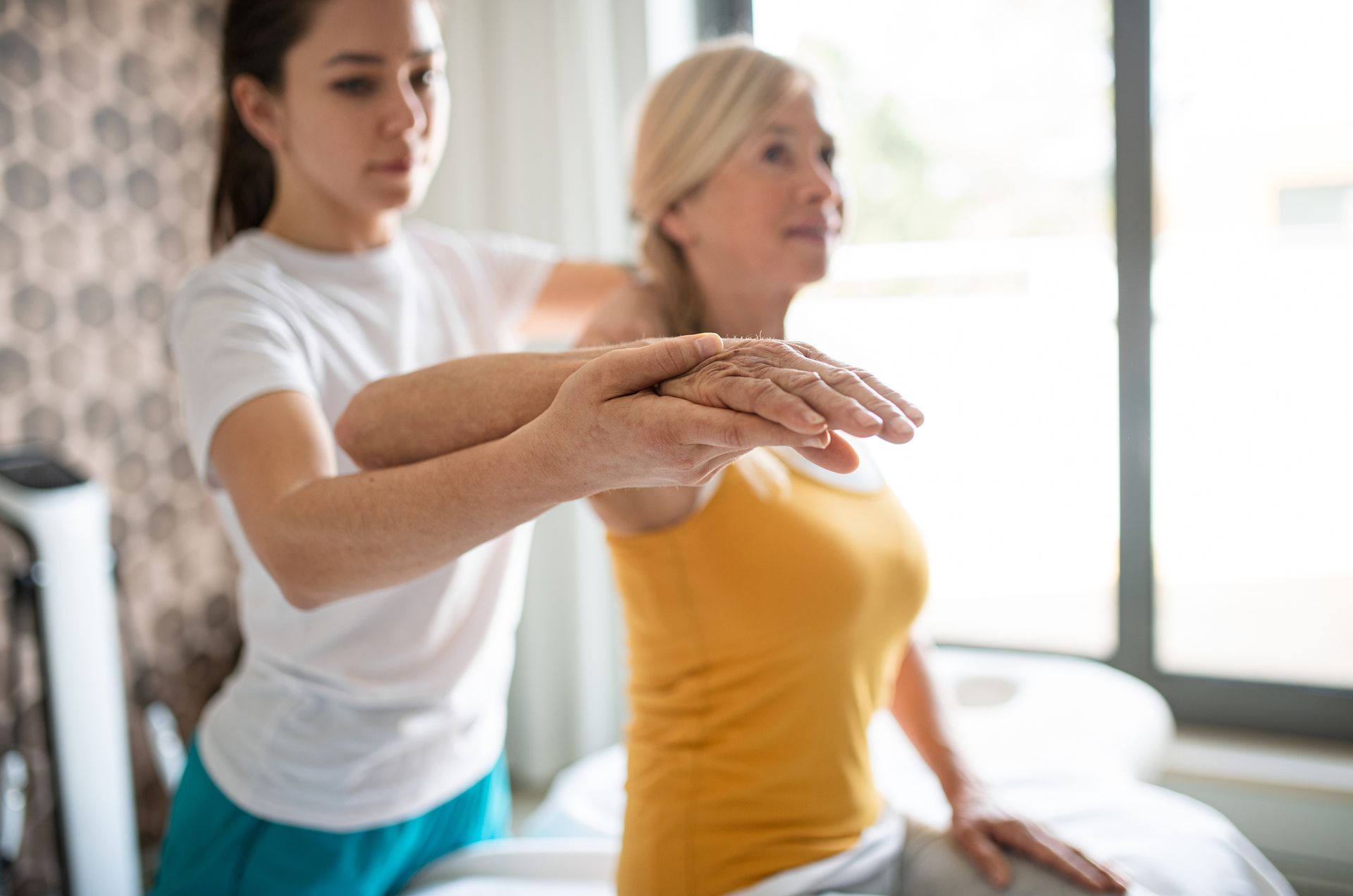 Chiropractor working with senior patient.