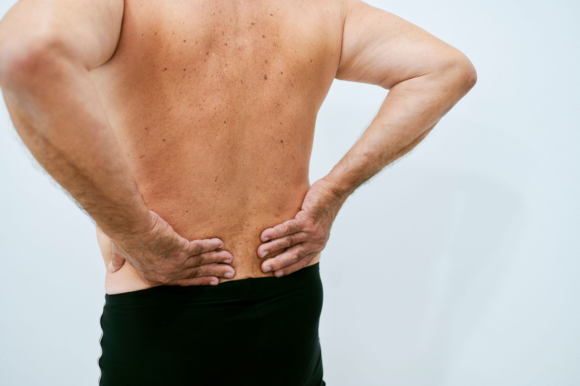 Close-up of senior man complaining of back pain.