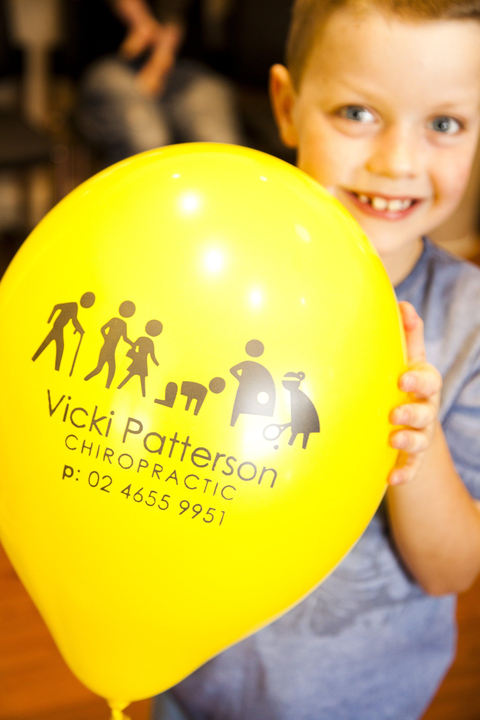 Boy Smiling Holding a Balloon — Camden, NSW — Vicki Patterson Chiropractic