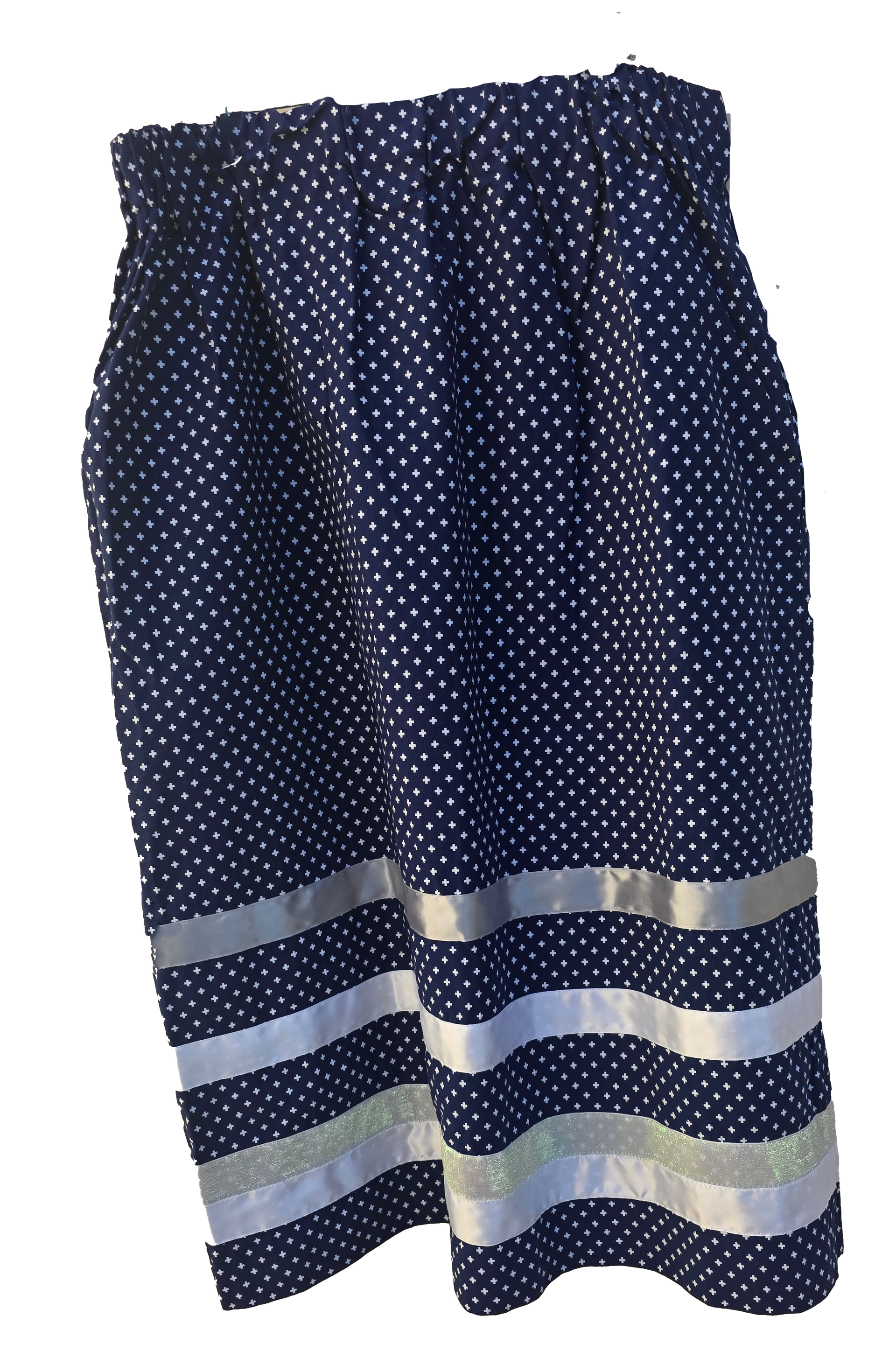 Navy blue skirt with white polka dots and silver ribbon stripes at the hem.