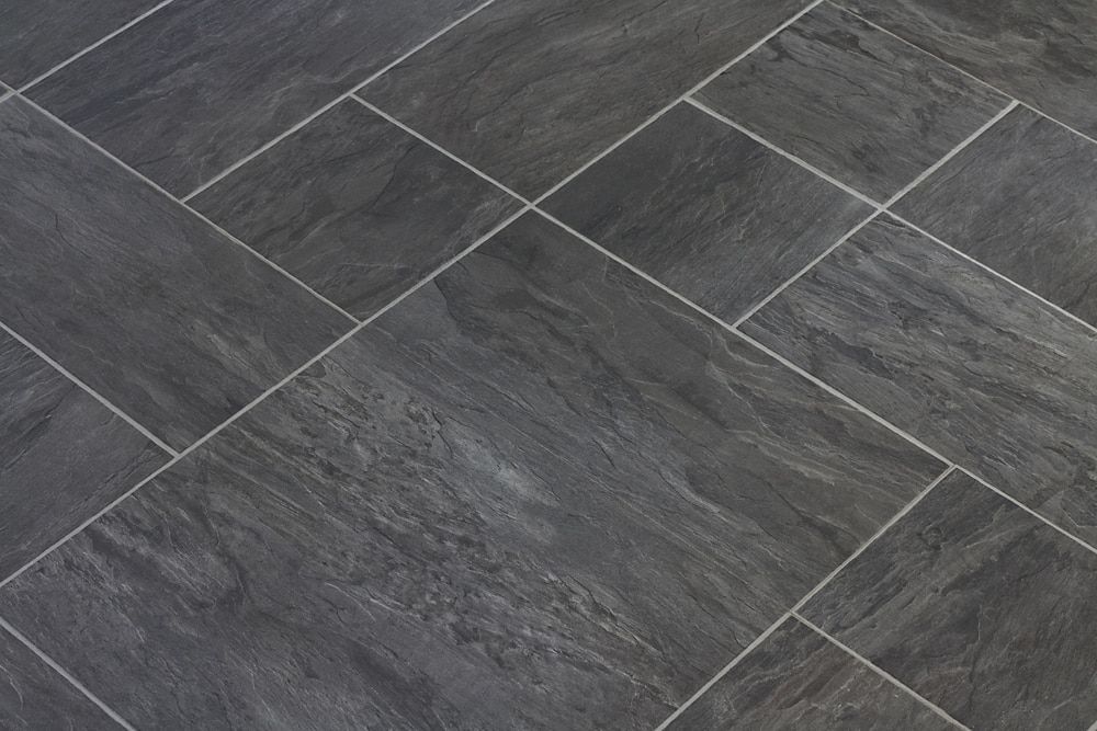 View of Dark Grey Rectangular Stone Tiles Laid in a Herringbone Pattern — Cobra's Carpet Cleaning in Junee, NSW