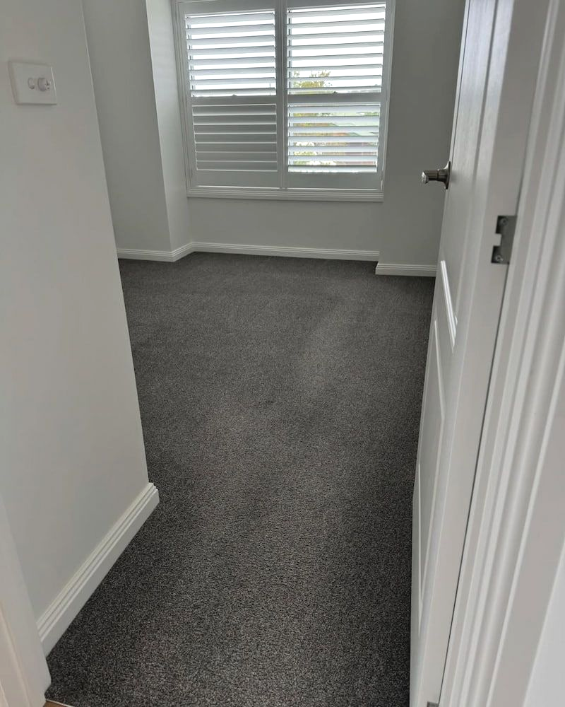 A Doorway View of an Empty Bedroom With Grey Carpet, Light Grey Walls — Cobra's Carpet Cleaning in Junee, NSW