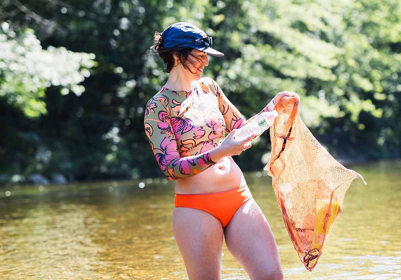 A woman collecting plastic bottles