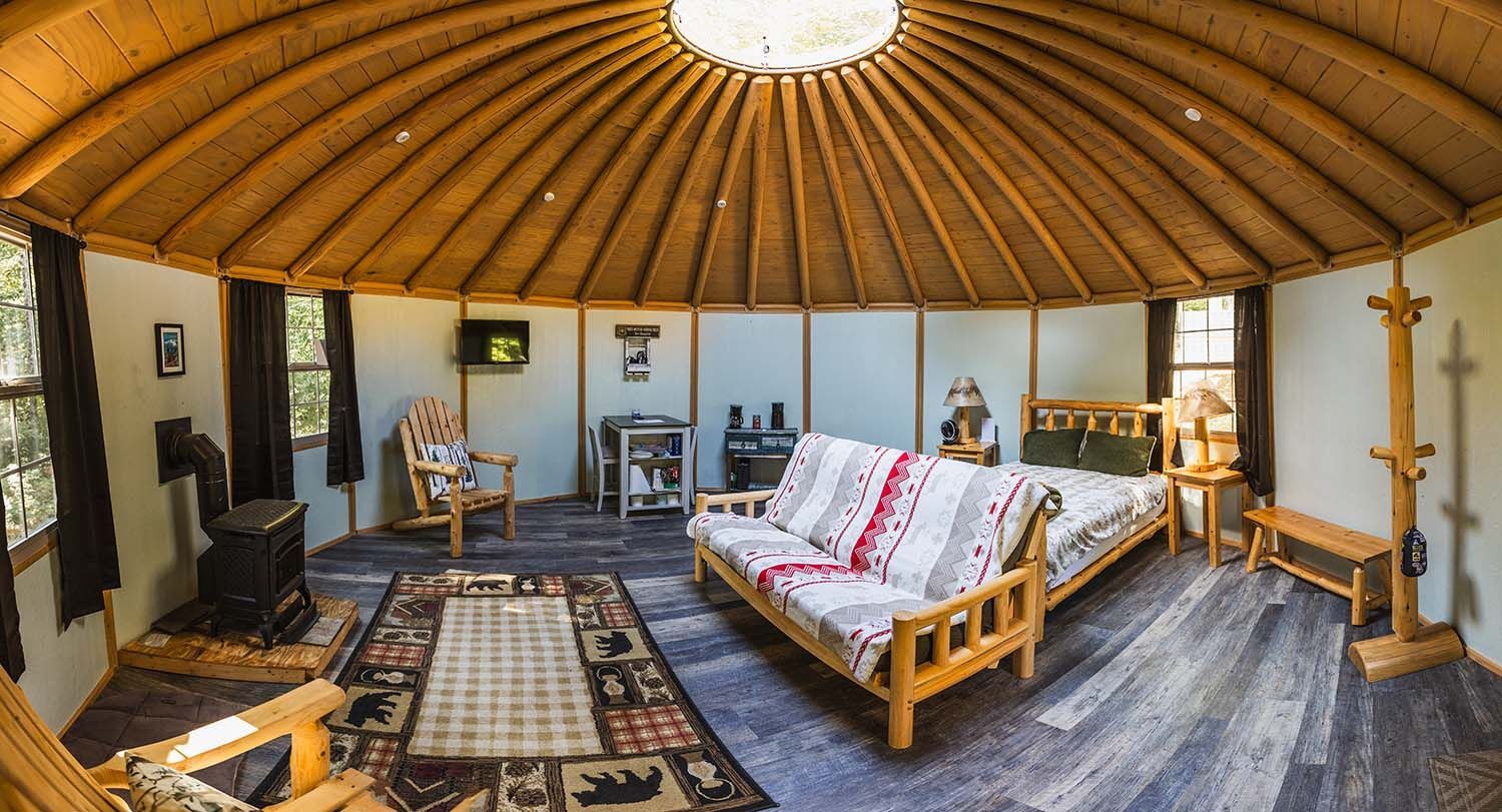 A Large Room with A Couch , Bed , Chairs and A Rug