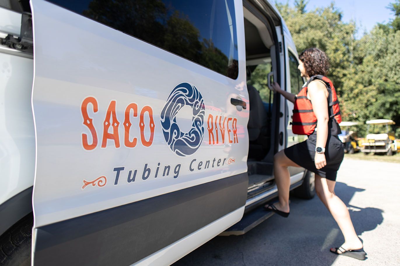 Woman in A Life Jacket Is Getting Inside Van