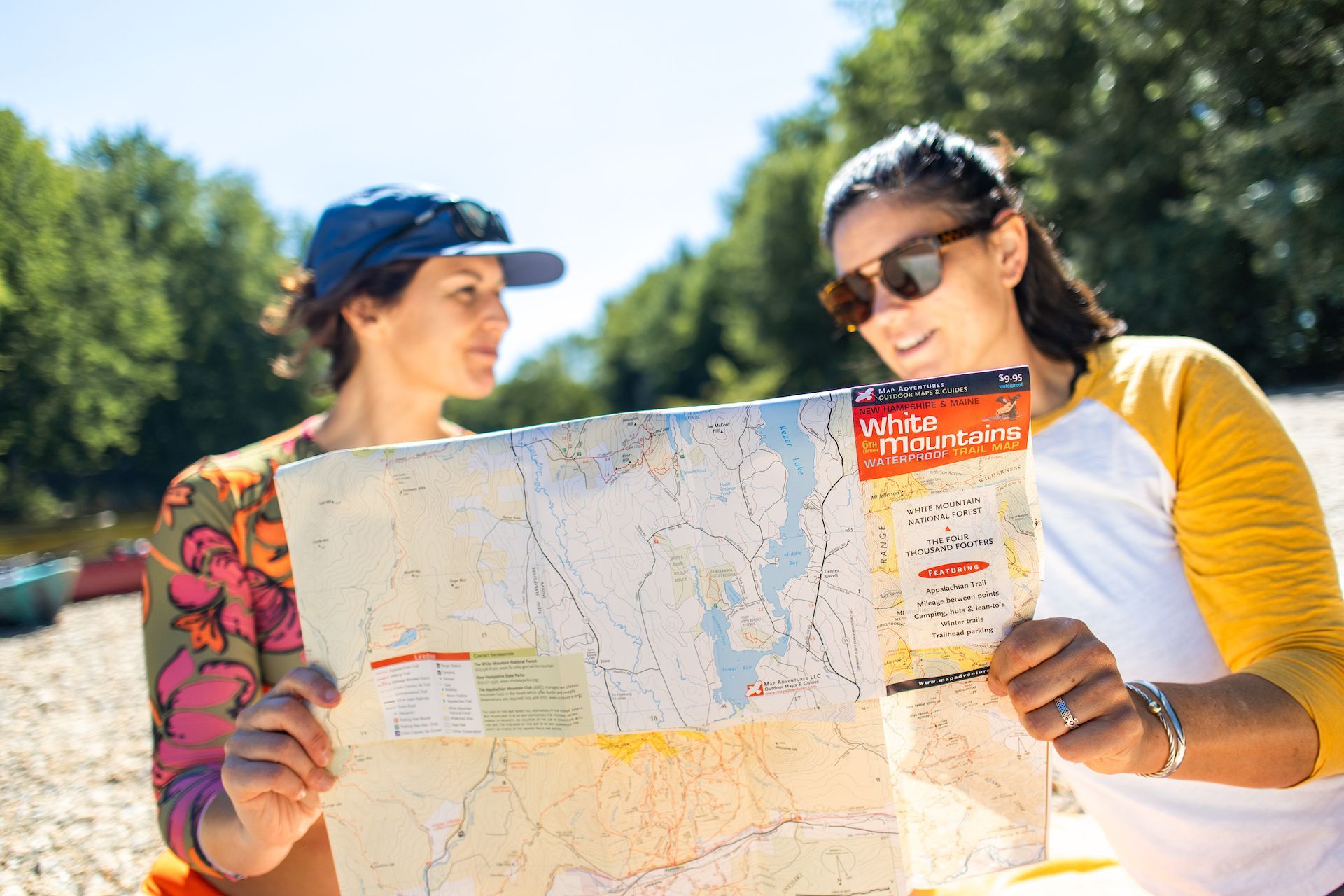 Two people look at a map of New Hampshire