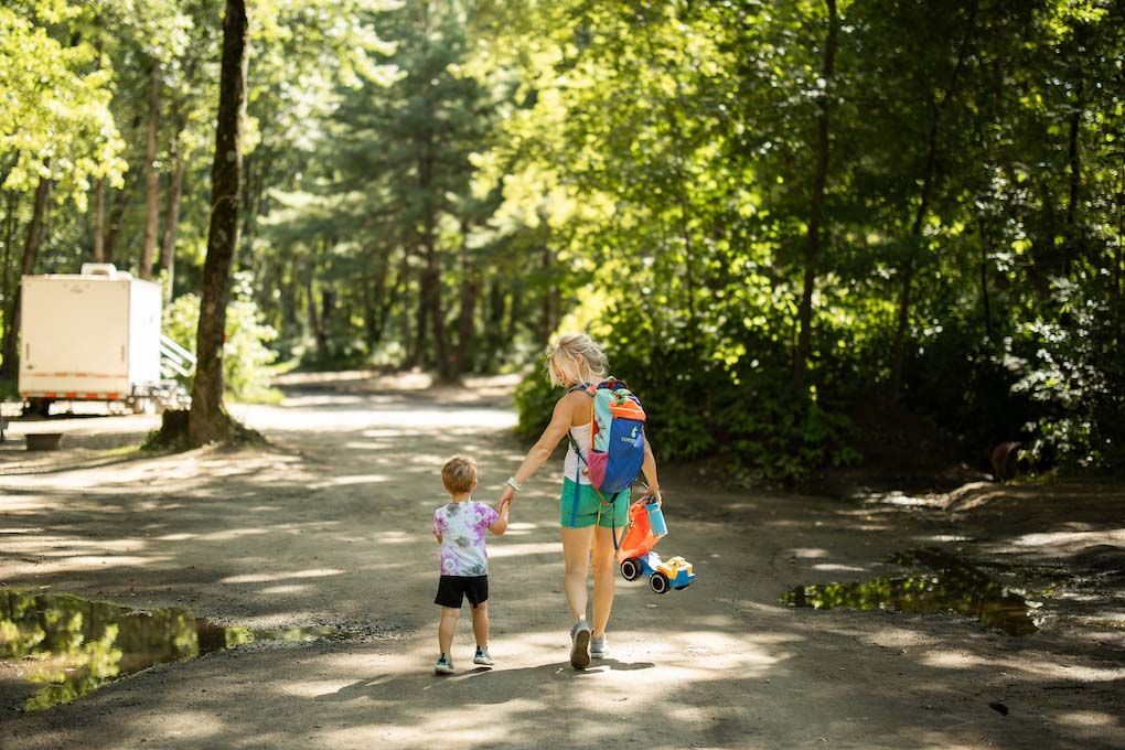 A mother and child are walking down while holding hands