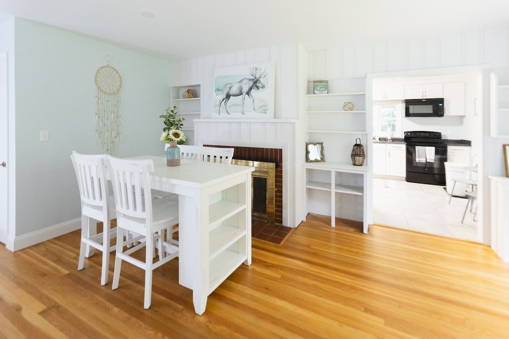 A Dining Room with A Table and Chairs and A Fireplace