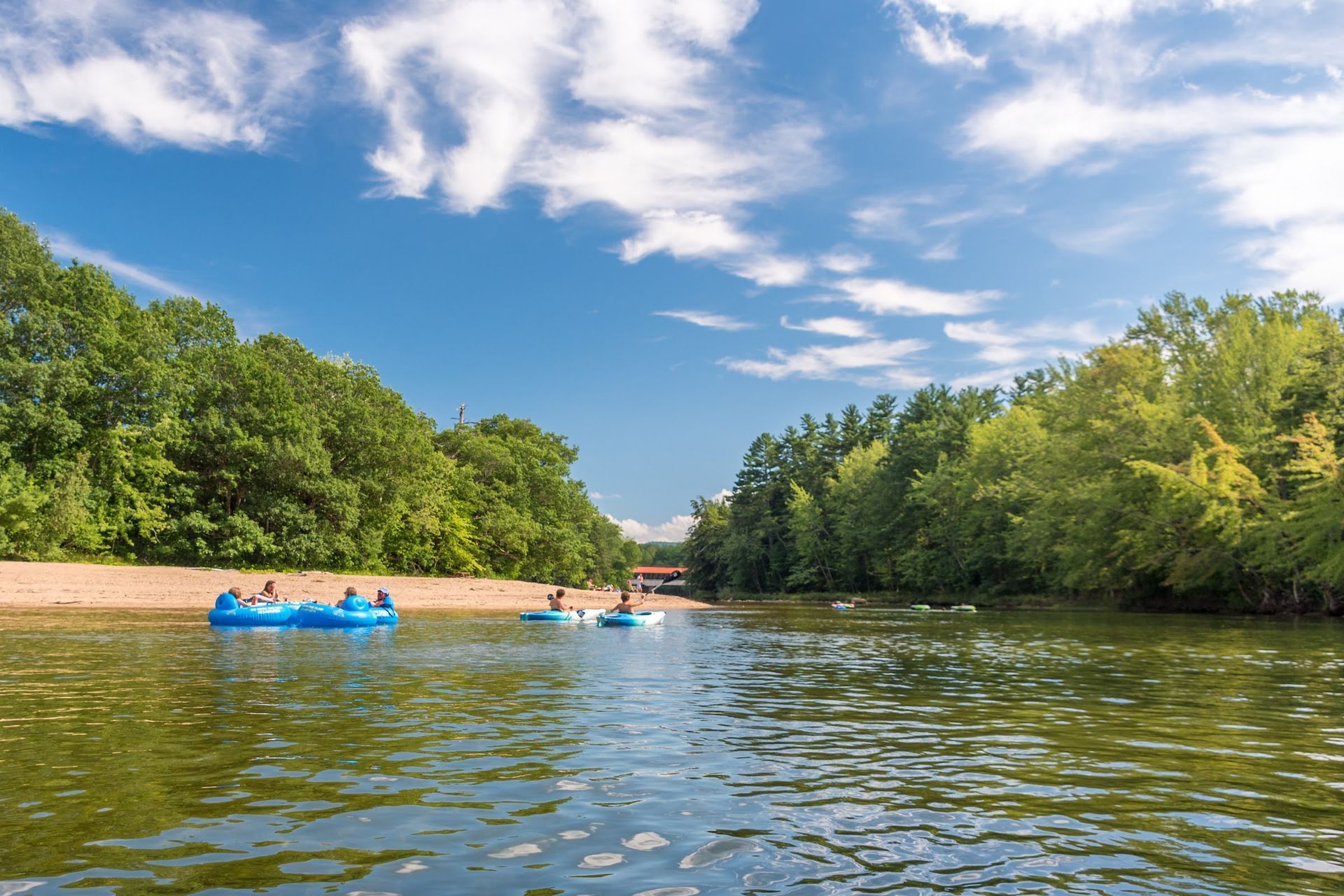 people tubing down the saco river