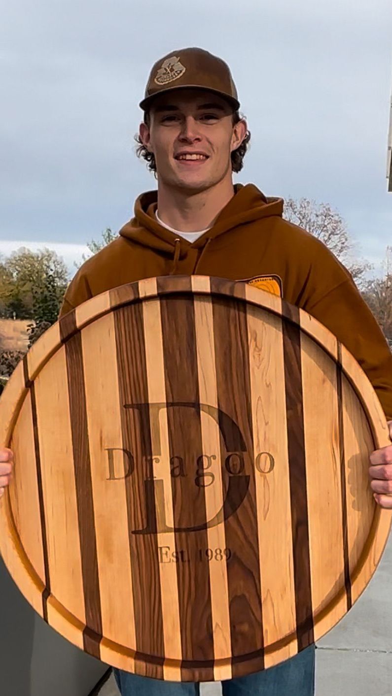 Young man holding a wooden platter with 