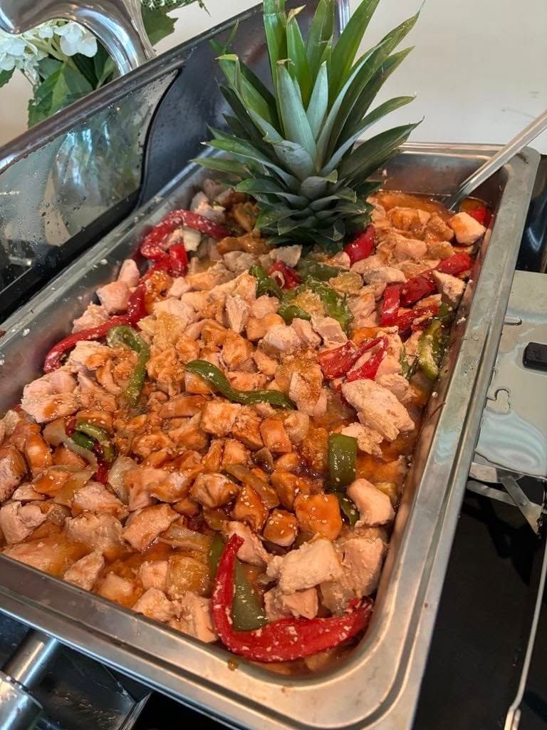 A tray of food with a pineapple on top of it.