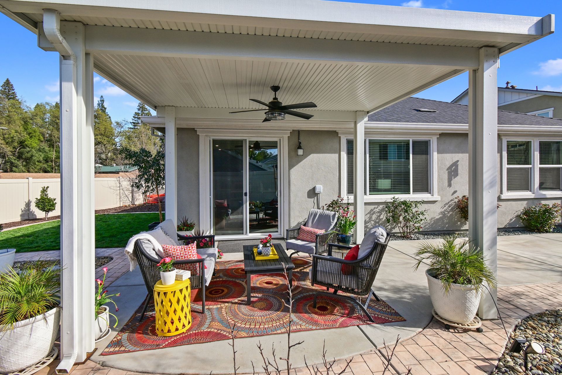 Daytime covered patio with lounge seating and ceiling fan, highlighted by a listing agent in Citrus Heights.