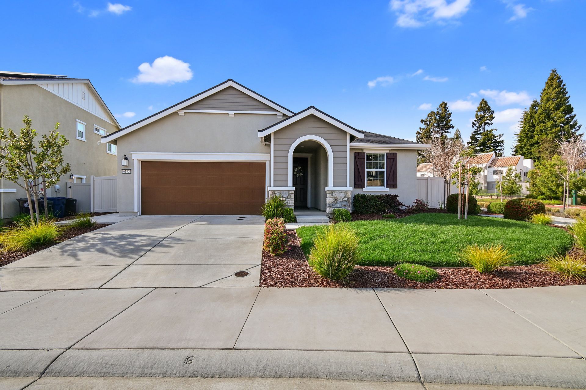 Front view of a single-story home with a wide driveway and landscaped yard, represented by a Citrus Heights realtor.