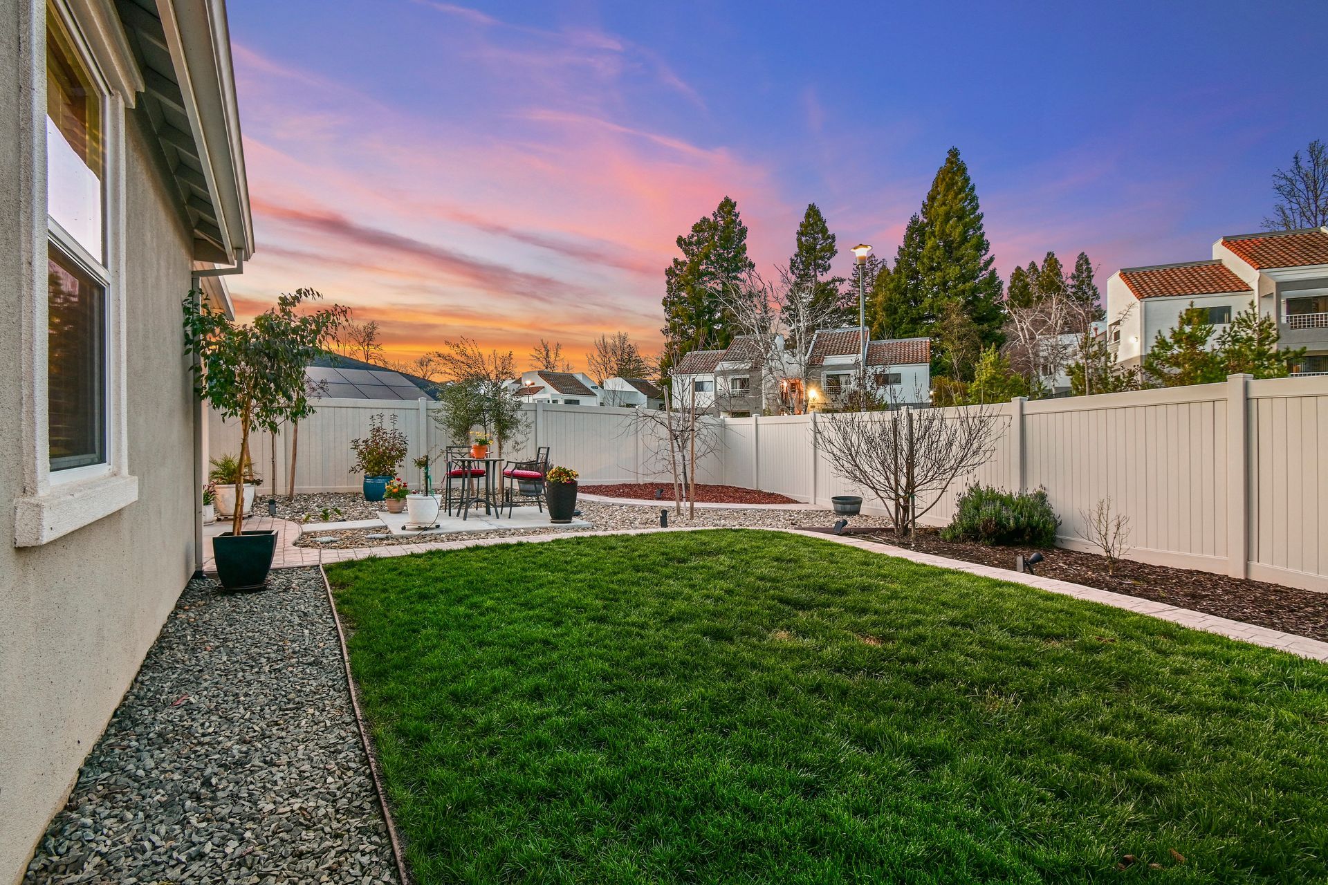 Sunset backyard with open lawn and fenced landscaping, presented by Nicole Spencer, top realtor in Citrus Heights.