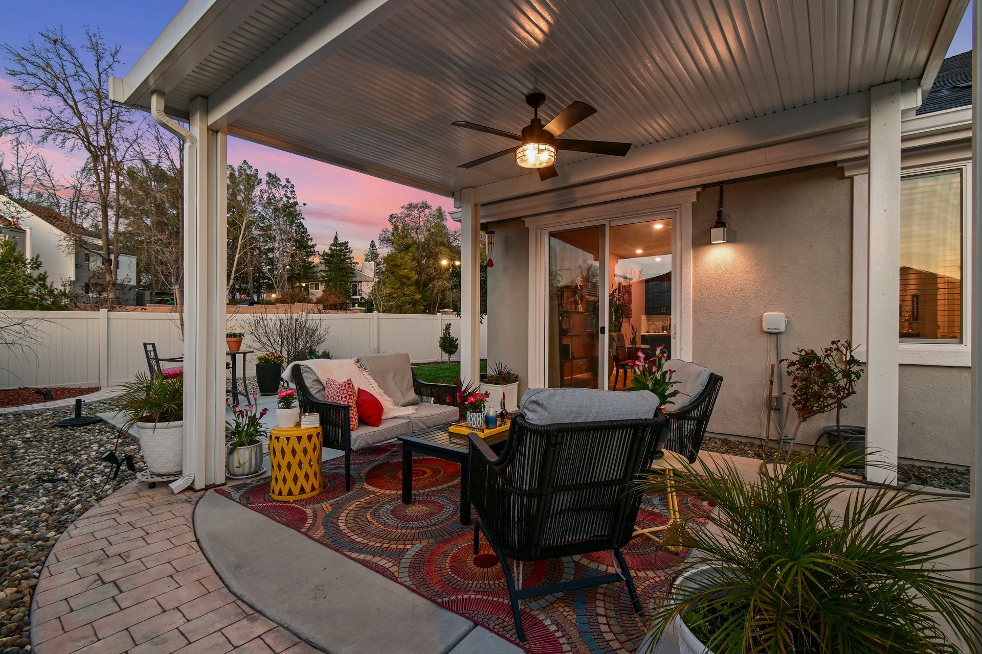 Covered patio with outdoor seating and ceiling fan, highlighted by top real estate agent in Citrus Heights.