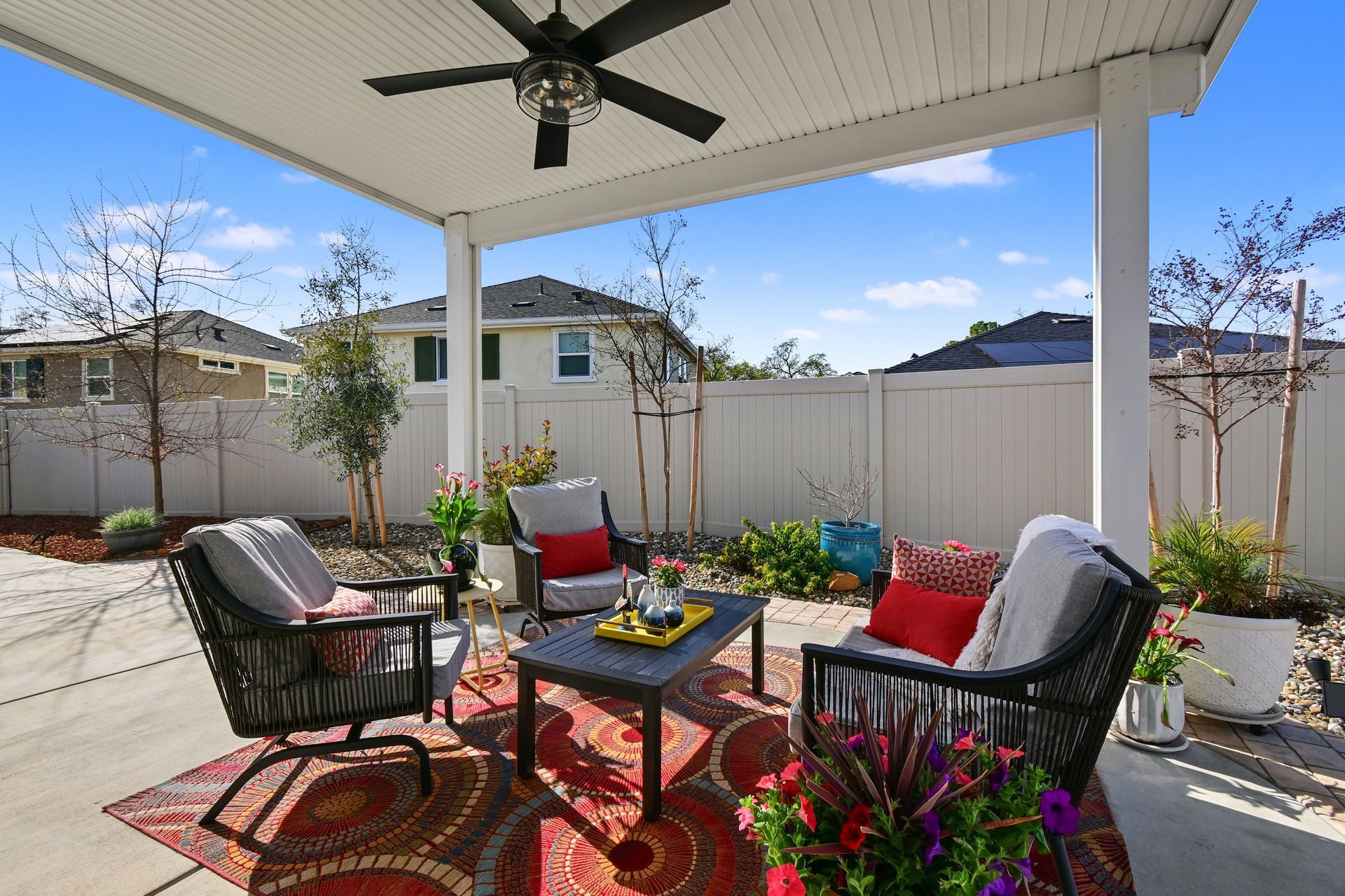Stylish outdoor living space with lounge chairs and fan, offered by the best listing agent in Citrus Heights.