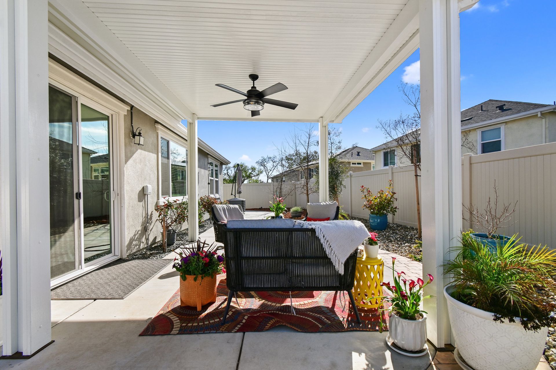 Spacious covered patio for relaxing with outdoor seating and a ceiling fan, listed by a top realtor in Citrus Heights.