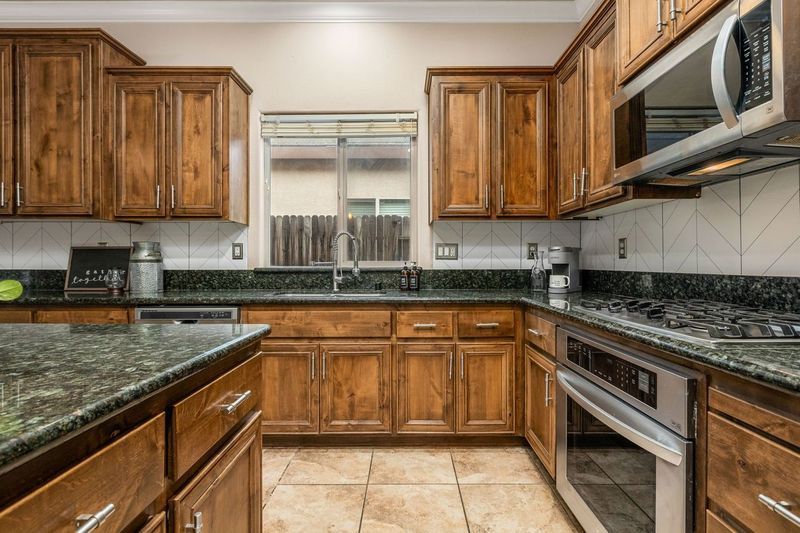 Open-concept kitchen on La Guardia Circle with an island, barn door, and stainless appliances.